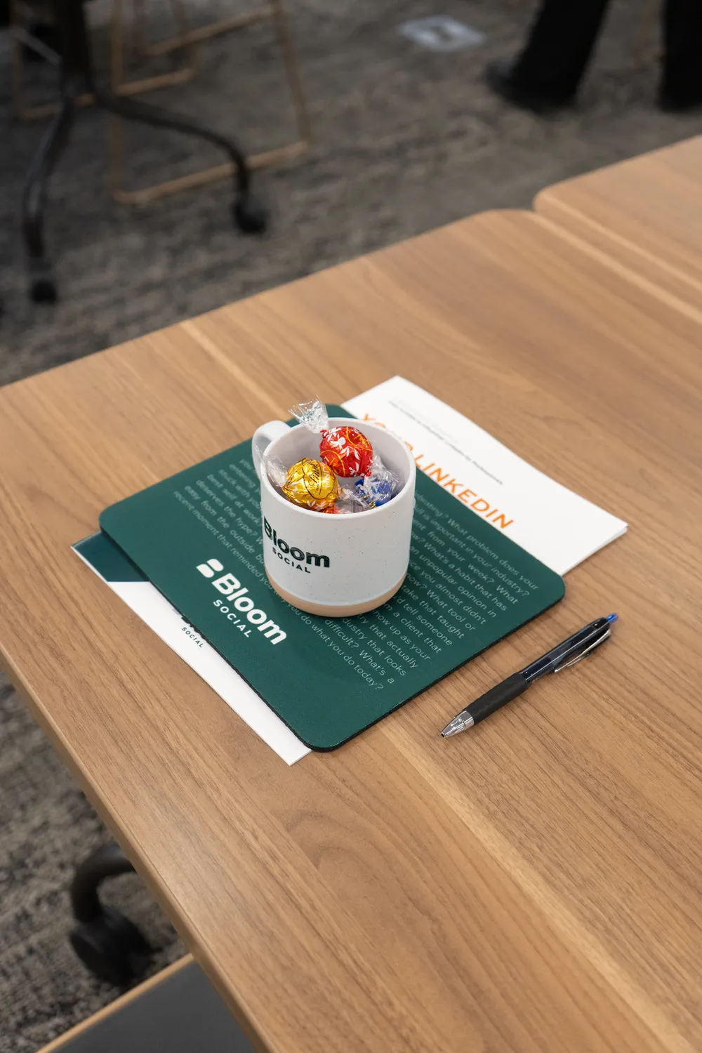 Bloom Social branded folder and mug on the table at the workshop